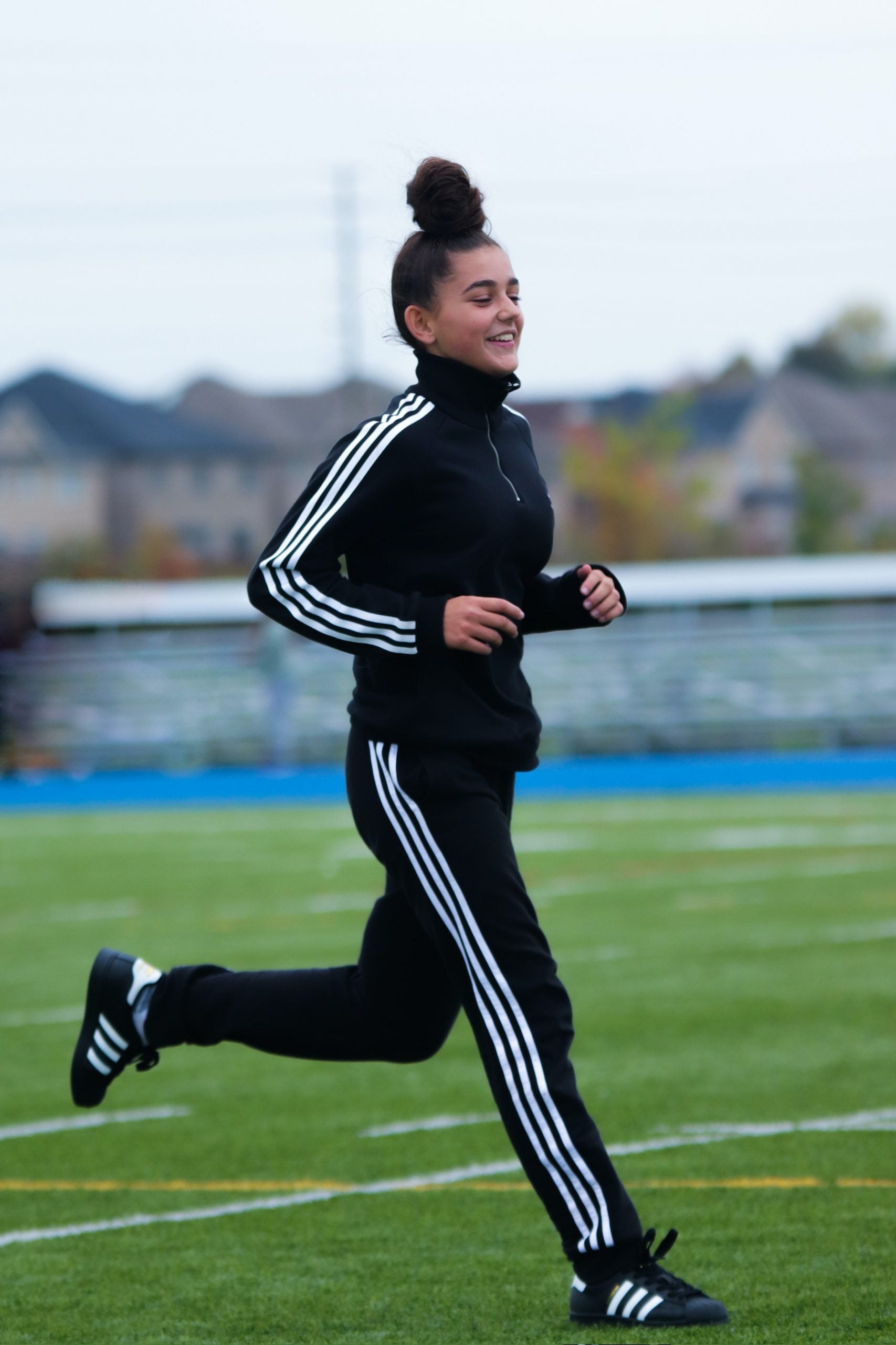 Girl running in tracksuit