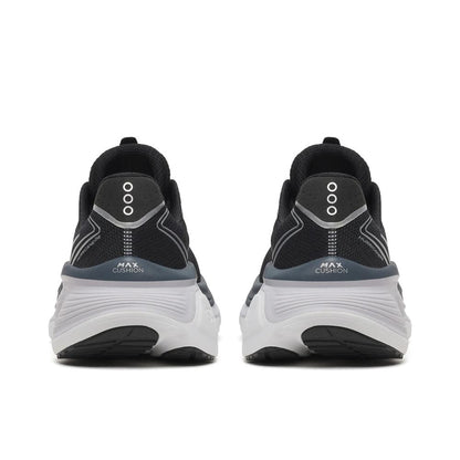A pair of Saucony Hurricane 26 Womens Running Shoes - Black/Silver shown from the back, featuring a chunky white midsole and the text 'MAX CUSHION' printed on the heel.